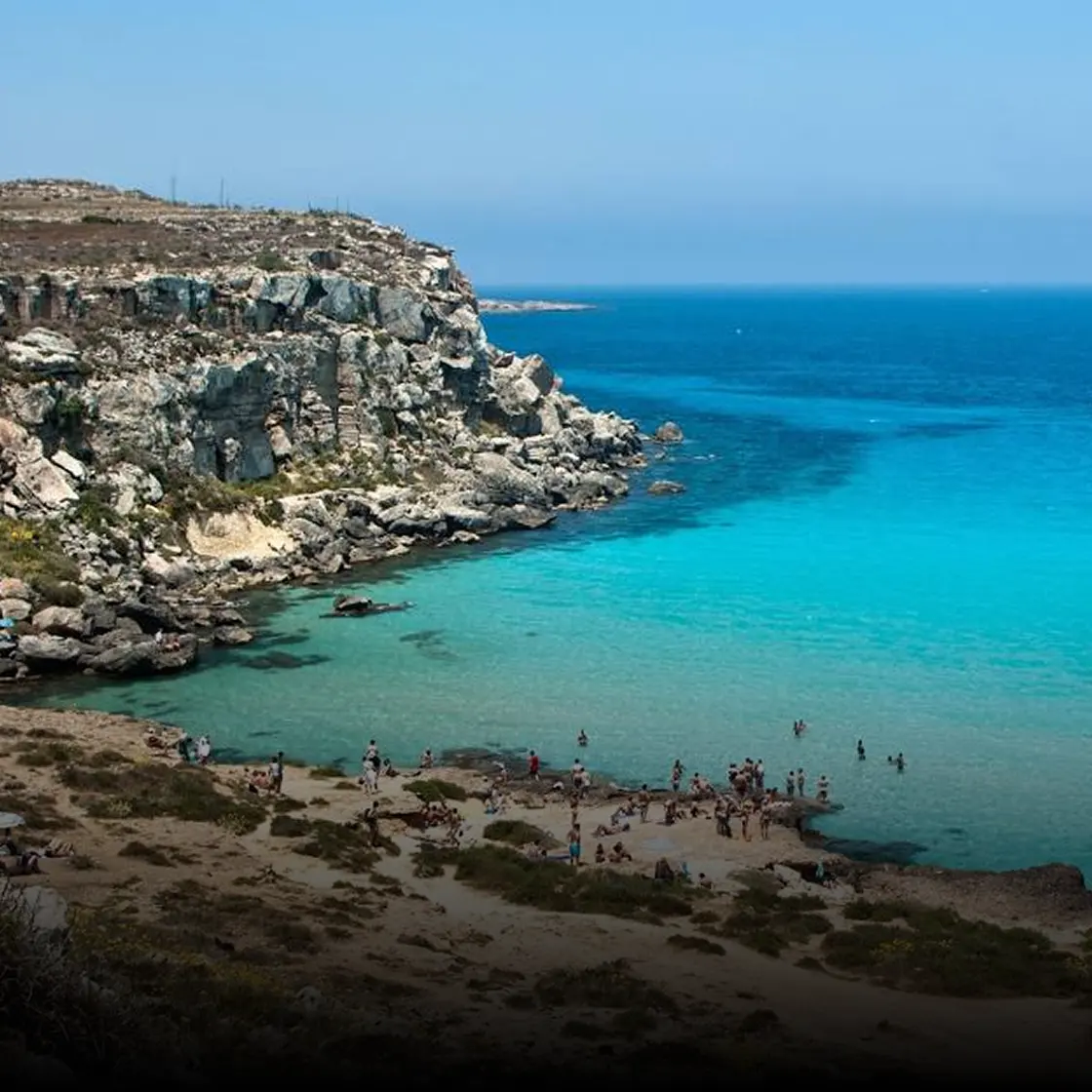 Turquoise water and limestone cliffs on a Sicilian island in summer
